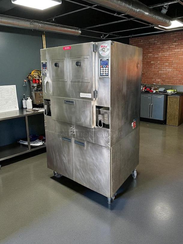 AutoFry commercial fryer with dual compartments, stainless steel exterior, keypad controls, and pull handles, on casters.