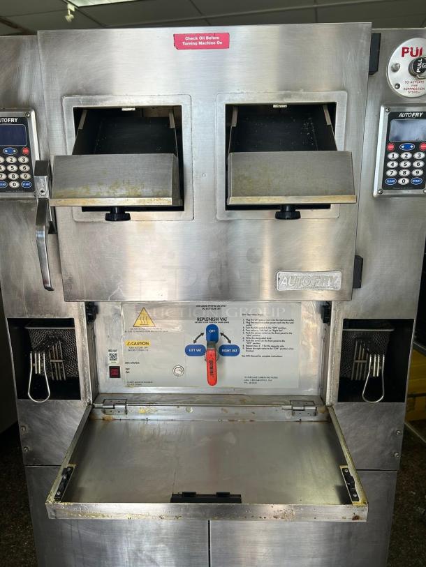 Commercial stainless steel deep fryer with dual compartments, digital controls, and safety instructions displayed. Used condition.