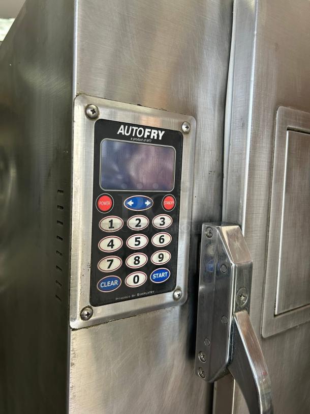 Stainless steel AutoFry machine with keypad, brand MTI, model visible, in used condition. Suitable for commercial frying.