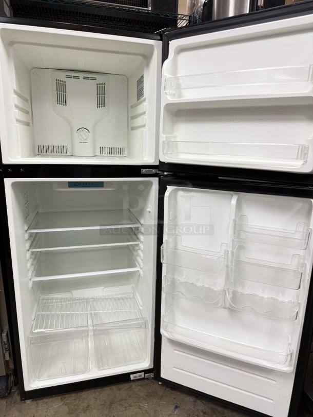 Magic Chef 7.3 cu. ft. 2-door mini fridge in black, includes freezer. Good condition, tested and working. 115v power.