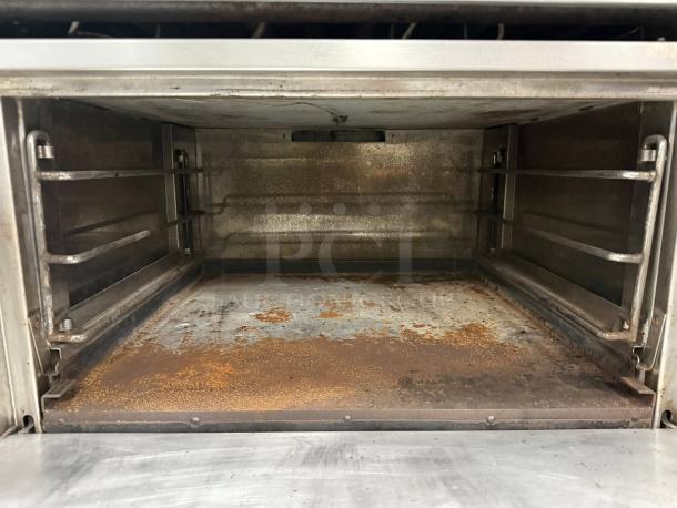 Jade JTRH-36G-36C Gas Range, open oven interior, showing wear. Features heavy-duty construction, 36" griddle, convection oven.