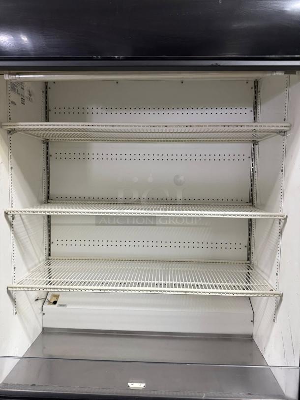 True TAC-48 Vertical Air Curtain Merchandiser Display, 34 Cu. Ft., black, shelves; in great condition, tested and working.
