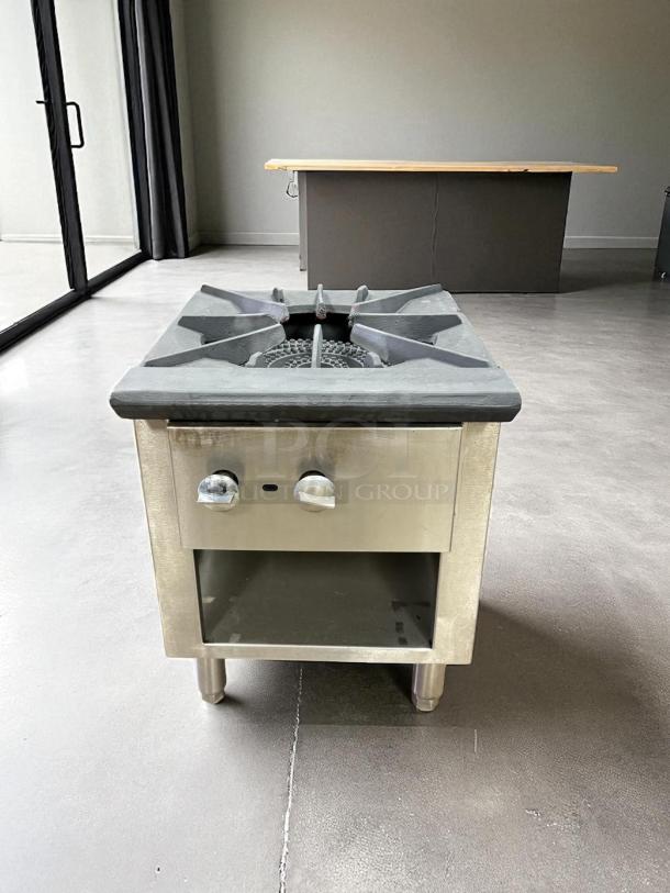 Commercial stock pot gas burner, 3-ring, stainless steel, great condition, with control knobs and open storage below.