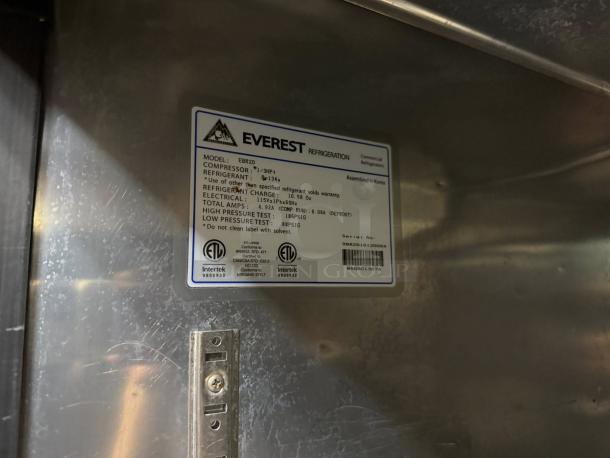 Everest EBR2 refrigerator interior label showing model, compressor, refrigerant, electrical details, and serial number.