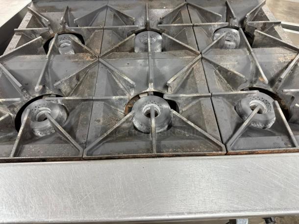 WOLF Model 36C-Y1R 6-burner commercial gas range. Used, tested, working condition. Steel surface shows wear.