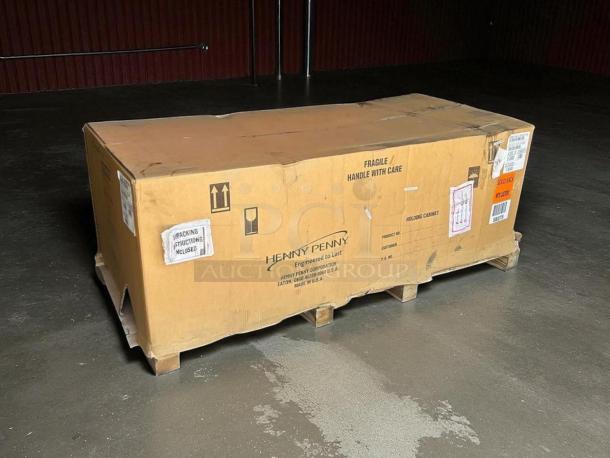 NEW Henny Penny HHC-900 insulated holding cabinet, in box on pallet. Box displays "FRAGILE" and product labels.