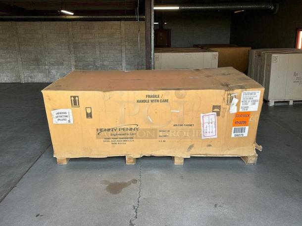 New Henny Penny HHC-900 insulated holding cabinet in box; stainless steel, SimpleHold controls, 120V, tags show shipping info.