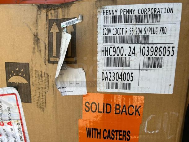 New Henny Penny HHC-900 holding cabinet in box. Features: stainless steel, insulated, SimpleHold controls, 120V. Label includes model and serial numbers.