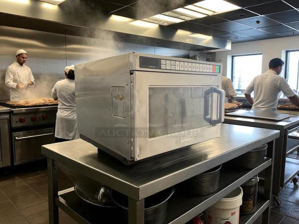 Panasonic NE-17723 1700W commercial microwave oven on stainless steel counter in a kitchen, great condition, tested working.