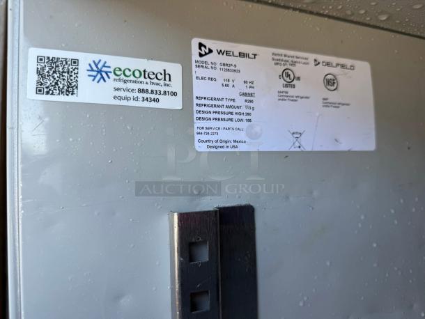 Delfield GAR2P-S two-section reach-in refrigerator, tested and working, shows manufacturer label with specs and 115v power rating.
