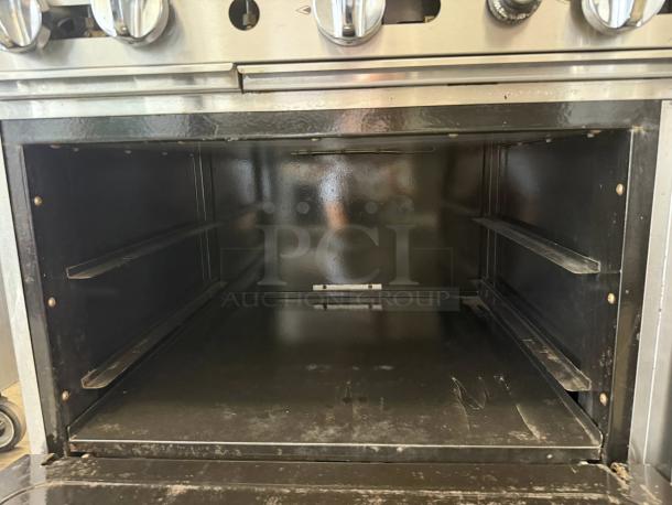 Atosa AGR-2B24GR 36" CookRite gas range oven interior, showing clean, spacious design and metal racks.
