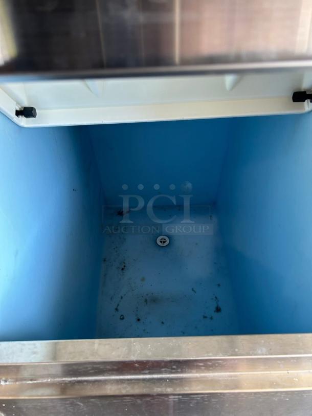 Hoshizaki KM-500MAH ice machine interior, showing clean blue storage bin with 300 lb. capacity, tested and working condition.