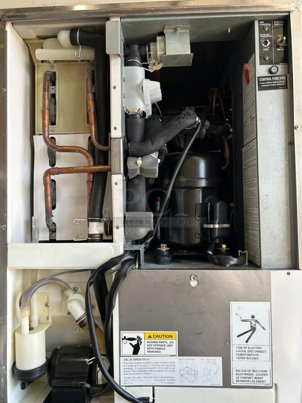 Hoshizaki KM-500MAH modular ice machine interior, showing copper tubing, controls, and caution labels. Tested and working condition.