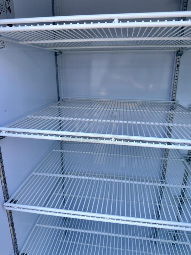 Beverage Air MMR66HC-1-W 75" white refrigerated merchandiser with sliding glass doors, LED lighting, and wire shelving.