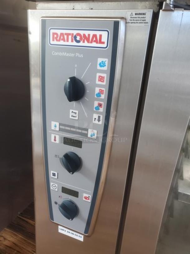 Rational Combi Master Plus oven on casters, electric model. Features control panel with knobs and display. Brand label visible.
