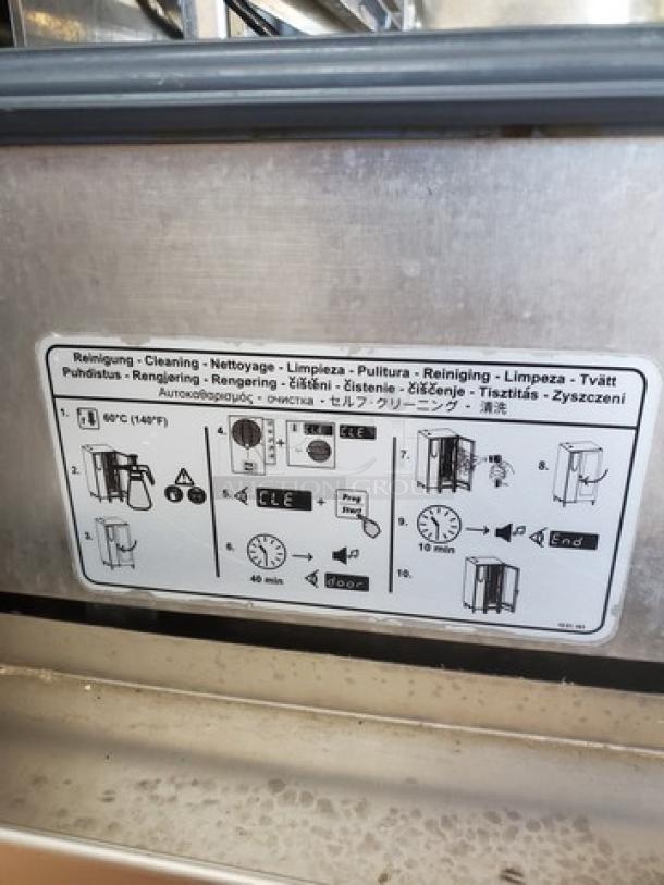 Rational Combi Master Plus electric oven on casters, cleaning instructions label visible.