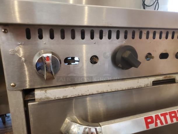 Patriot 6 Burner Range, model FMGR-36/NG. Natural gas, 210,000 BTU. Missing 3 knobs, on casters, standard oven base.