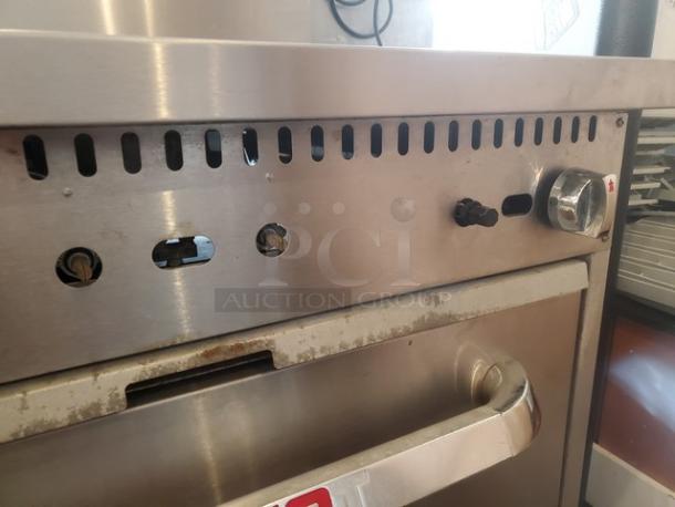 Patriot 6 Burner Range, Model FMGR-36/NG, with standard oven base on casters. Natural gas, missing 3 knobs, 210,000 BTU.
