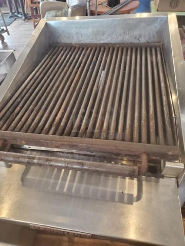 MagiKitch'n CM624 Charbroiler, stainless steel, used condition, features cast iron grates, suitable for commercial use.