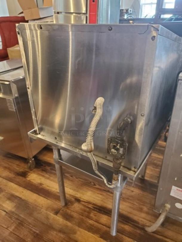 MagiKitch'n Model CM624 Charbroiler, stainless steel, lightly used condition, visible gas connection, sturdy legs.