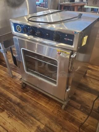 Alto Shaam 767-SK undercounter cook and hold smoker oven, stainless steel, 125V, 1 PH, 60 Hz, 1920W, on casters.
