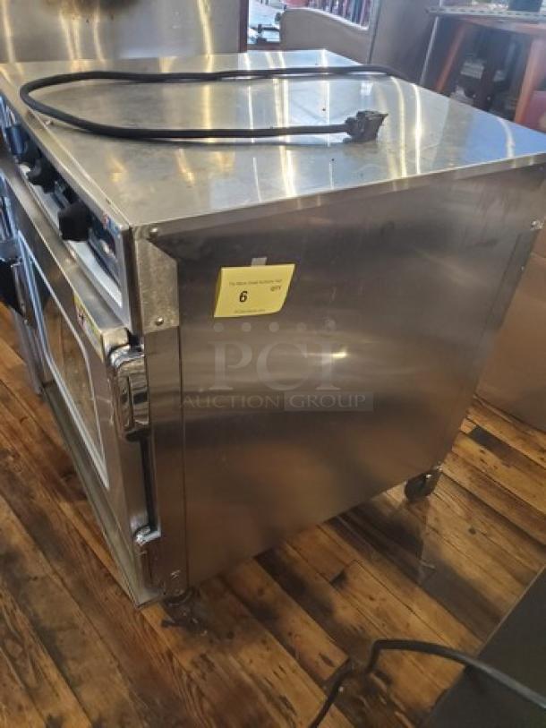 Alto Shaam 767-SK Undercounter Cook and Hold Smoker Oven, stainless steel, 125V, 1 PH, 1920W, on wheels, auction tag visible.