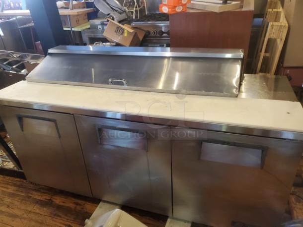 True TSSU-72-16 72" sandwich/salad prep table, stainless steel, 1/2 HP, 115V, 60Hz, needs caster replacement.