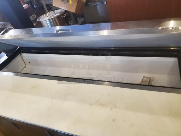 True TSSU-72-16 72" sandwich/salad prep table, 1/2 HP, 115 V, 60 Hz, 1 PH. Casters need replacement. Pre-owned condition.