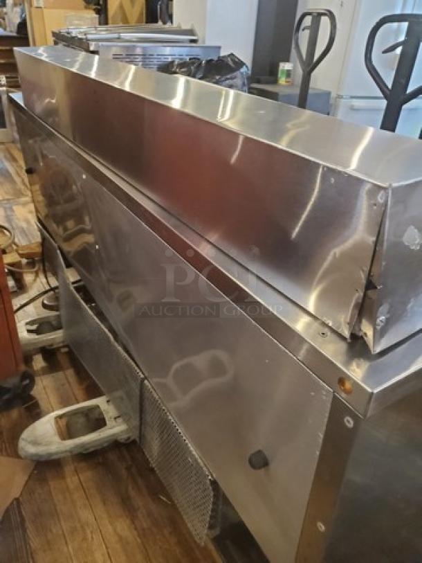 True TSSU-72-16 Sandwich/Salad Prep Table, 72", stainless steel, visible wear, casters need replacement. Model tag included.