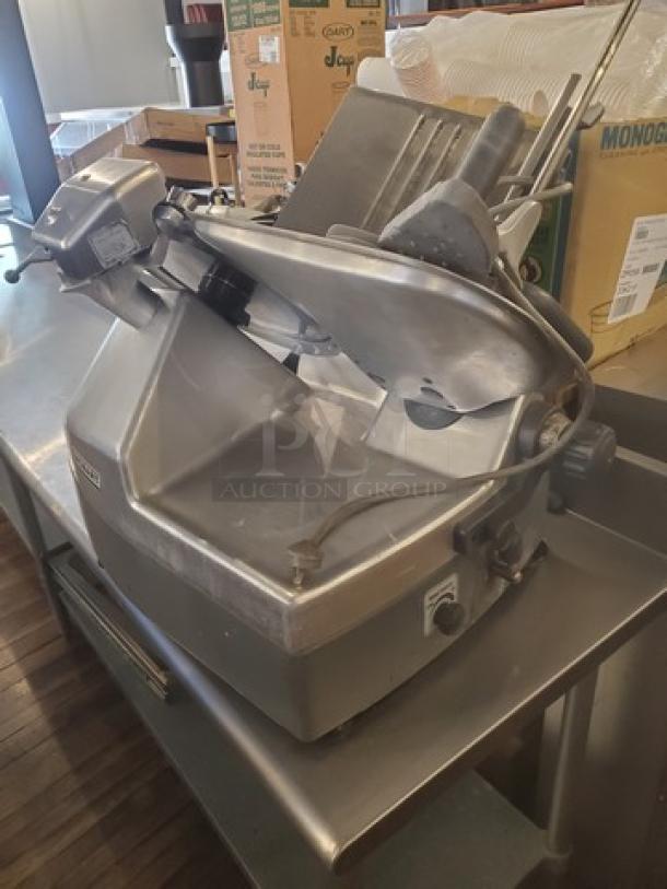 Hobart 2912 12" automatic meat slicer, 1 PH, 120V, 6A, 60 Hz, 1/2 HP, used condition on stainless steel counter.