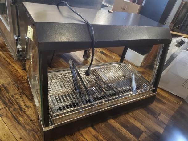 Vollrath FMA7036 hot food cabinet, black, with metal racks. 120V, 1440W, 12.5A, 60 Hz. Visible power cord. Good condition.