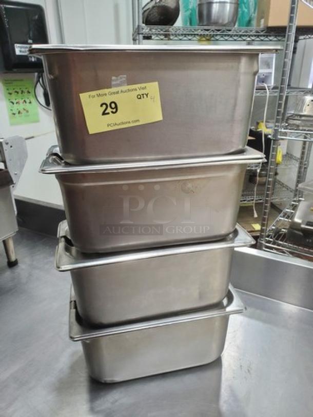 Lot of 4 Vollrath 6.1 Qt stainless steel food pans with lids, stacked. Yellow auction tag reads "29 QTY 4". Good condition.