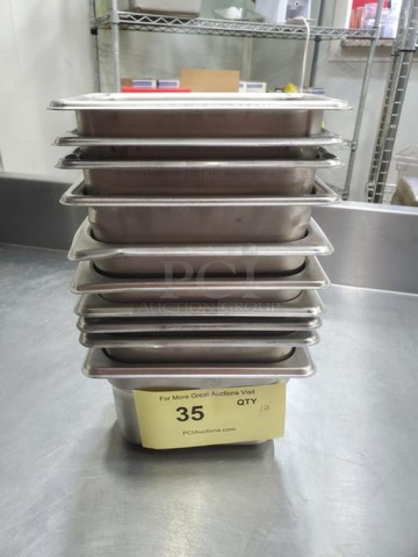 Lot of 10 stainless steel food pans, 1.1 qts each, stacked, used condition, auction label with lot number 35.