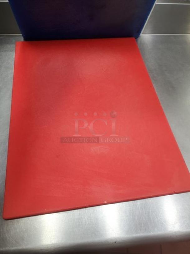 Lot of 3 cutting boards in varying colors, used condition with surface marks, durable and ideal for kitchen use.