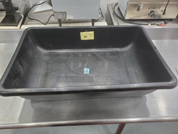 Large black mixing tub with smooth interior, wide rim, and label marked "46." Appears in good condition on a stainless table.