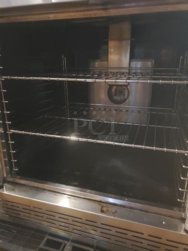 Imperial Natural Gas Convection Oven, stainless steel interior, multiple racks, well-maintained, professional kitchen equipment.