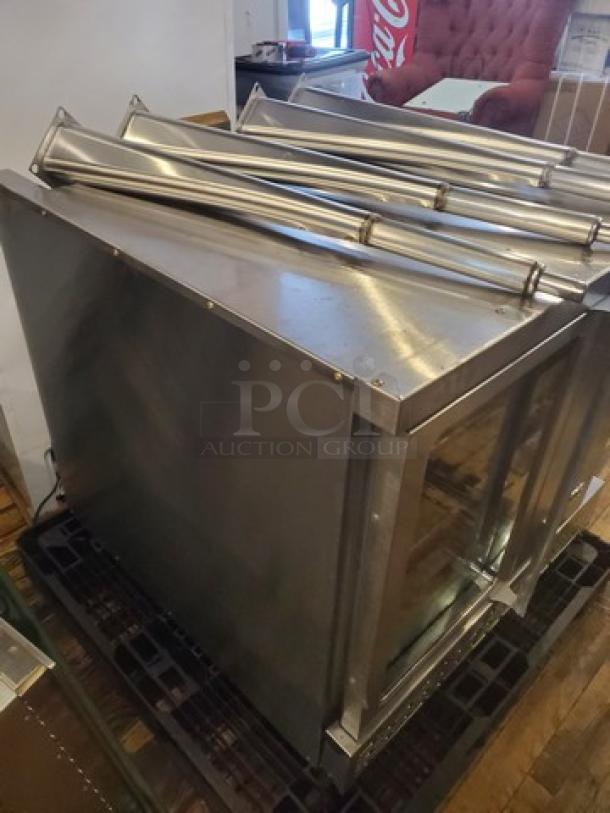 Imperial Natural Gas Convection Oven, stainless steel, used condition, visible piping on top, sturdy frame, resting on pallet.