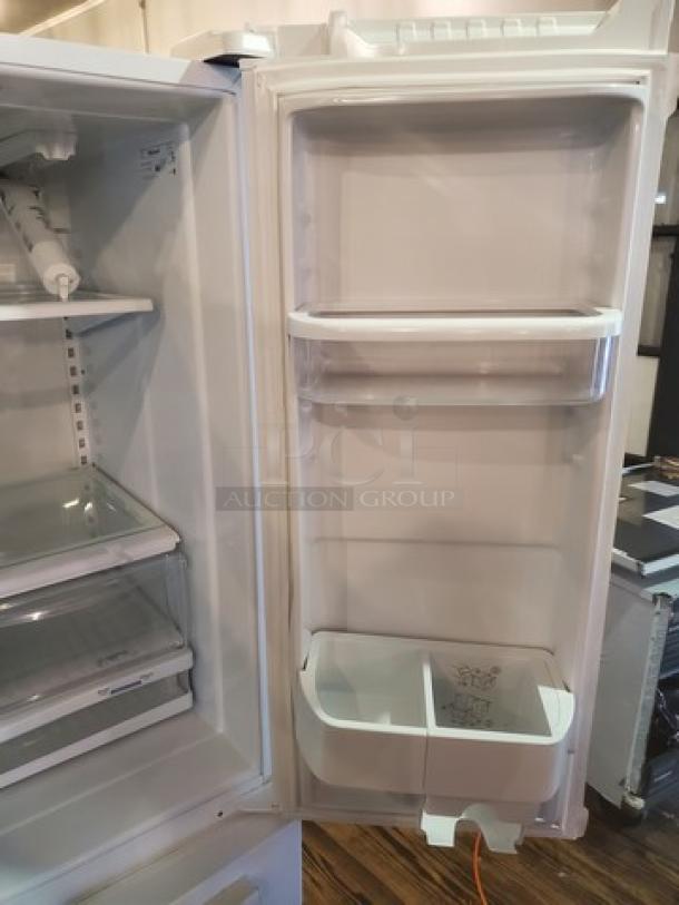 Whirlpool GX5FHTXVQ06 French door refrigerator, 24.8 cu. ft., open door view, clean interior, shelves intact.
