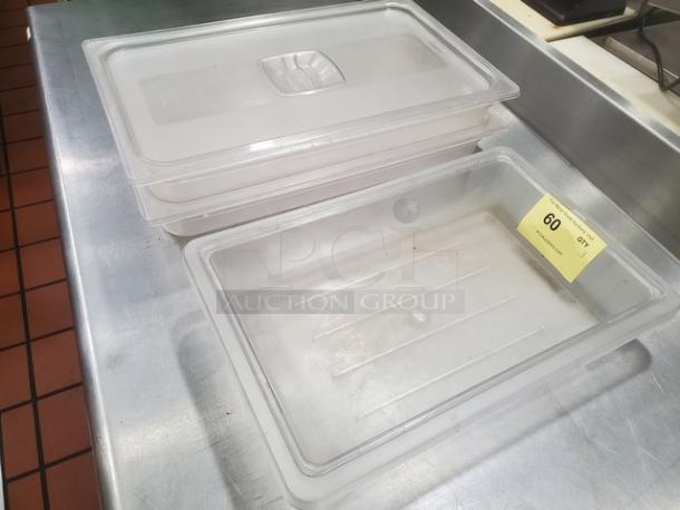 Lot of 3 clear plastic food pans, two with lids; used condition. Numbered tag "60" attached to one pan.