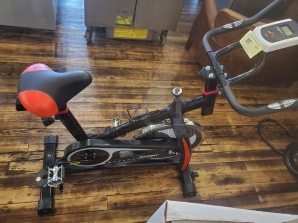 Mini Cycling Exercise Bike, black and red, features adjustable seat and handlebars, digital display, good condition.