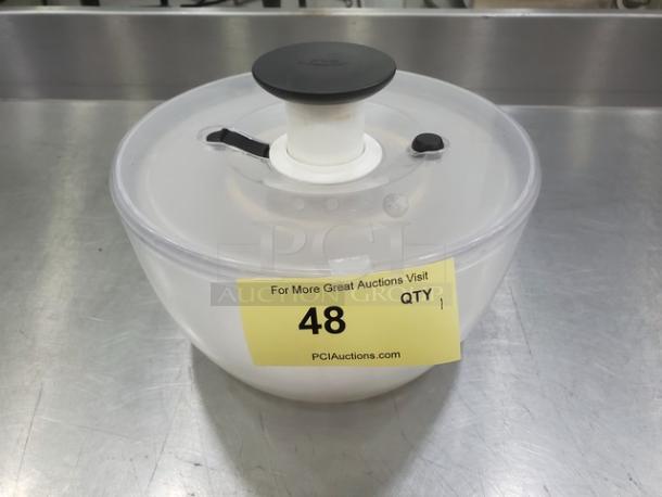 Clear salad spinner with black handle and lid, item label 48 displayed on side.