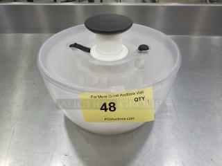 Clear salad spinner with black handle and lid, item label 48 displayed on side.