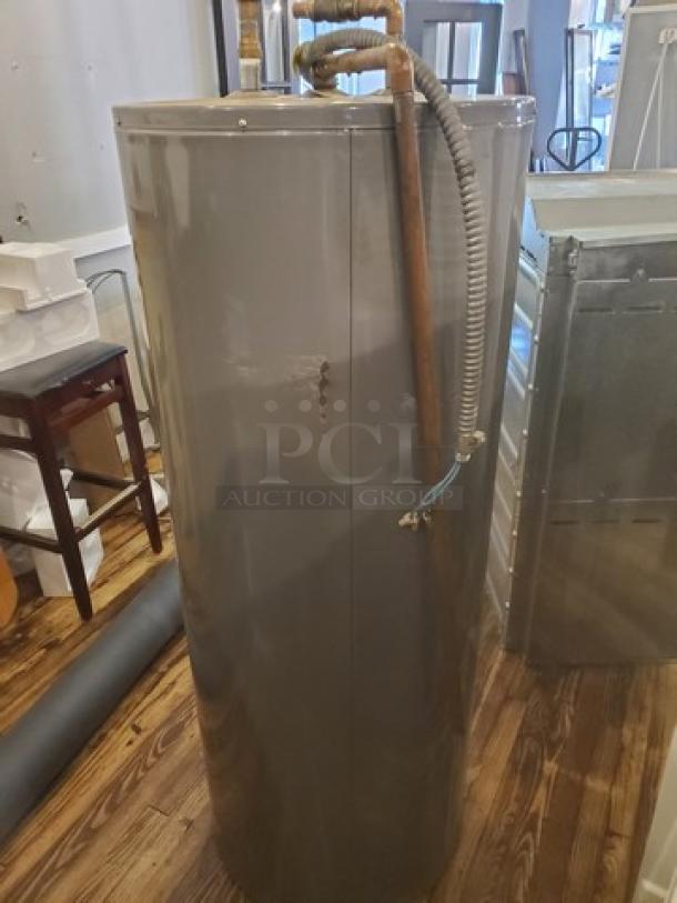 Rheem Performance 80 Gal. Water Heater, Model XE80T06ST45U0, in used condition. Visible piping and surface wear.
