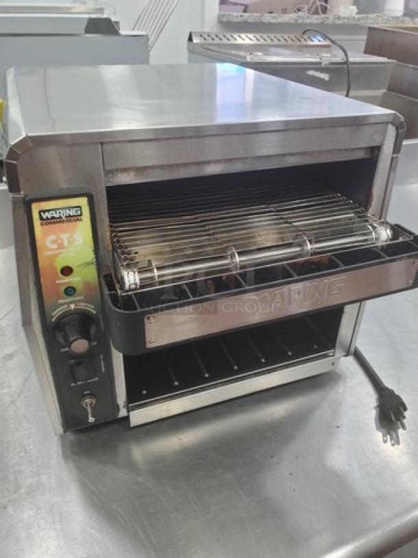 Waring CTS1000 Conveyor Toaster, stainless steel, 120V, 60Hz, 1800W, features adjustable controls, visible branding, good condition.