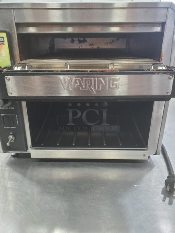 Waring CTS1000 Conveyor Toaster, stainless steel, 120V, 60 Hz, 1800W, used condition. Front view with visible controls and logo.