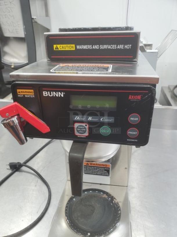 Bunn AXIOM DV-3 coffee brewer with dual volt, two upper warmers, one lower warmer, in good condition with caution labels.