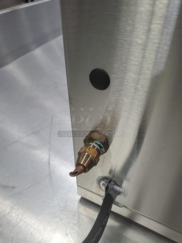 Bunn AXIOM DV-3 coffee brewer, stainless steel side view, electrical cord visible, in excellent condition.