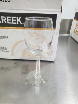 Clear glass wine goblet from a lot of 18, featuring a simple stem design. Appears in excellent condition.