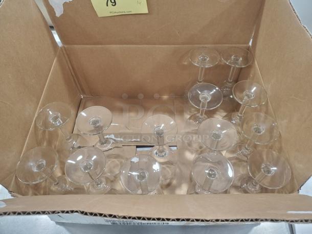 Lot of 14 clear glass stemmed glasses in a cardboard box; appear in good condition.