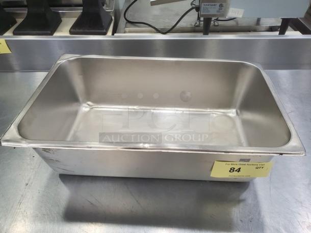 Stainless steel Amko food pan, rectangular, used condition, visible scratches. Auction tag reads "84 QTY 1."
